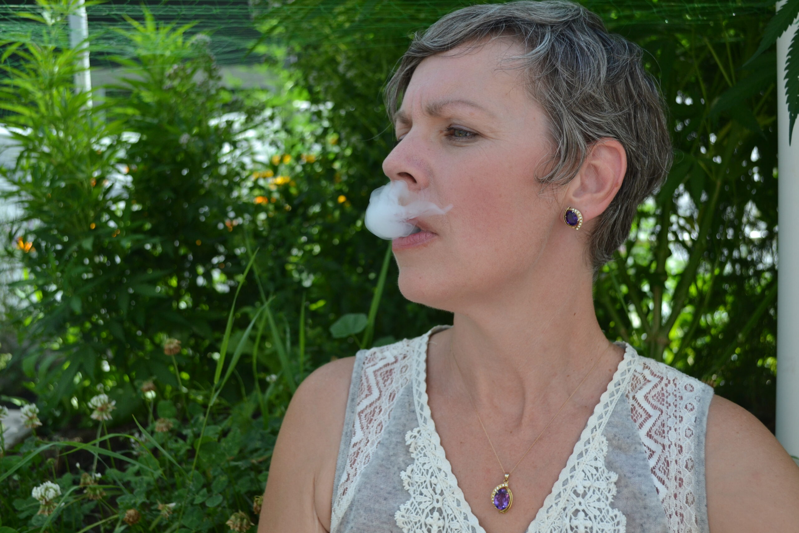 puff of smoke coming out of womans mouth